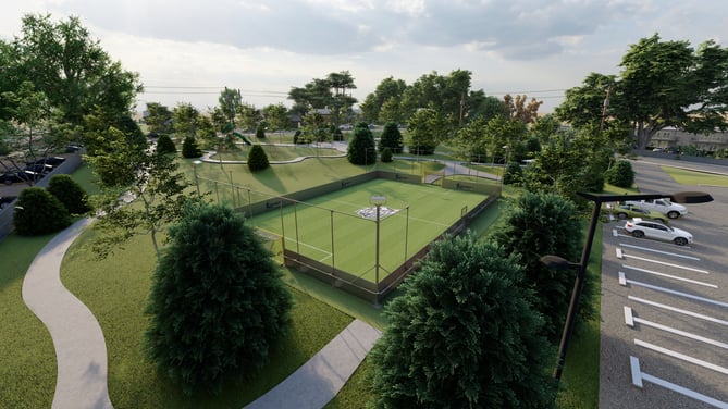 Aerial view of a 5-a-side soccer pitch in a landscaped community park with parking area.