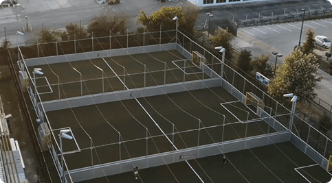 Aerial view of modular outdoor sports courts at Fusion Sports Park, featuring soccer, padel, cricket, volleyball, and pickleball courts as part of Phase 1A development.