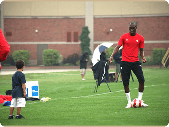 anadian soccer legend Atiba Hutchinson inspiring a young child on the field at Fusion Sports Park in Brampton