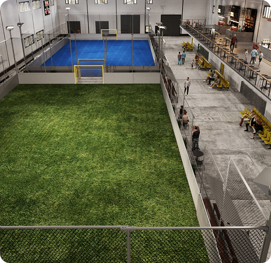 Interior view of Fusion’s indoor sports facility with mini-pitch, futsal court, bleachers, and café area
